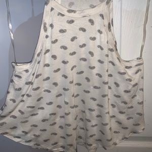 White and black tank top with a design all over.
